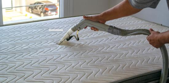 home cleaner vacuuming mattress